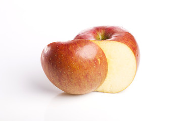Fototapeta na wymiar cutting red apple closeup isolated white.