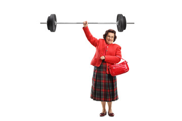 Senior lady lifting a barbell with one hand