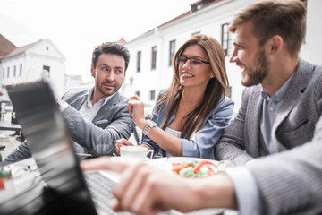 close up.business team sitting at a table in a street cafe