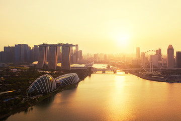 Downtown Singapore city in Marina Bay area. Financial district and skyscraper buildings. Aerial view at sunset.