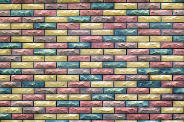 fragment of the wall with masonry of decorative bricks in different color schemes