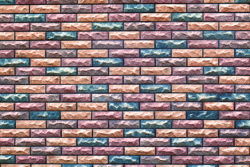 fragment of the wall with masonry of decorative bricks in different color schemes