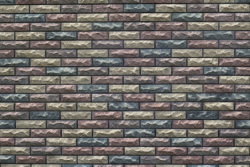 fragment of the wall with masonry of decorative bricks in different color schemes
