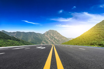 Empty asphalt road and mountains natural scenery at sunrise