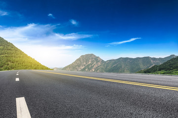 Empty asphalt road and mountains natural scenery at sunrise