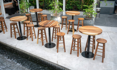 Fototapeta na wymiar Dining wooden tables with wooden chairs for dining out