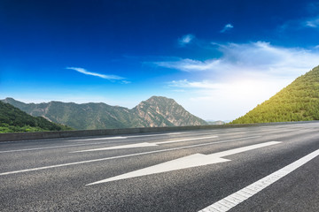 Empty asphalt road and mountains natural scenery at sunrise