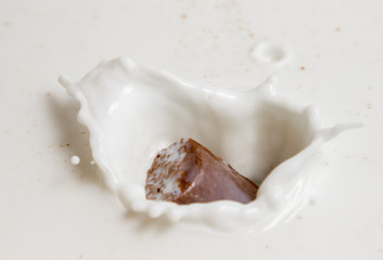 Chocolate falls in milk