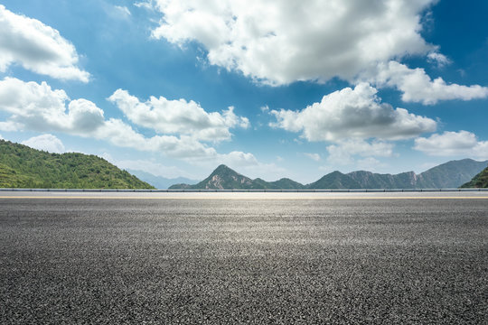 Empty asphalt road and mountains natural scenery under the blue sky
