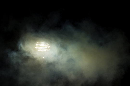 Light Tower Lit At A Stadium During Nightime.