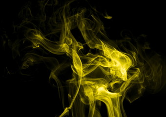 Yellow smoke on black background