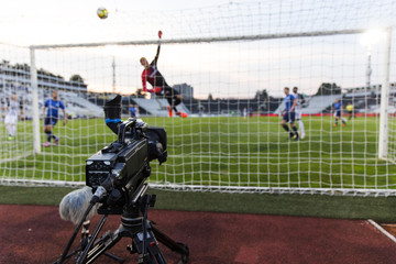 TV camera behind the football goal at the stadium during football matches