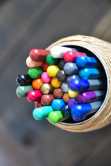 colored pencils on a wooden brown background
