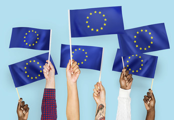Hands waving flags of the European Union - obrazy, fototapety, plakaty
