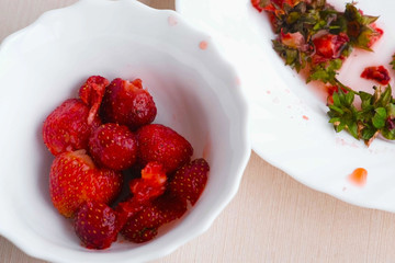 Peeled strawberries in a bowl.