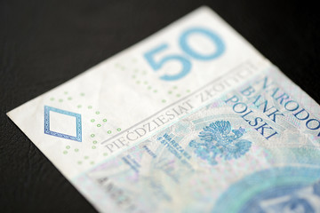 Fifty Polish zlotys on a dark background close up
