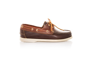 Close up of a brown mens top-sider boat shoes with white sole on white background with reflection....