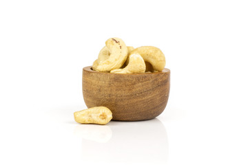Lot of whole raw cashew nut with wooden bowl isolated on white background