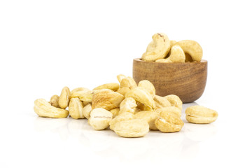 Lot of whole raw cashew nut with wooden bowl isolated on white background