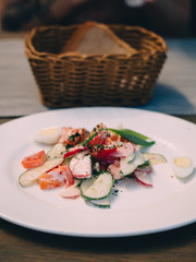 Plate of fresh vegetable salad in cafe table