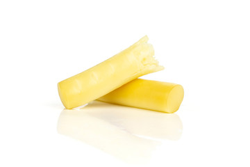 Group of two halves of smoked slovak string cheese stick isolated on white background