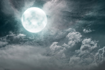 Naklejka na ściany i meble Dramatic view of full moon with dark clouds