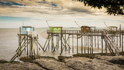 Fototapeta premium Row of fishing huts on elevated wooden stilts