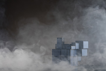 Rubik's cube on the dark or wooden background with smoke. Modern Rubik's cube.