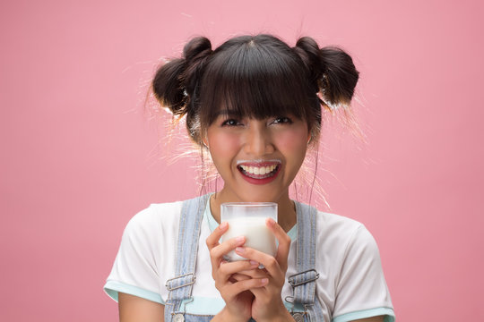 Young Pretty Woman Holding A Glass Of Milk