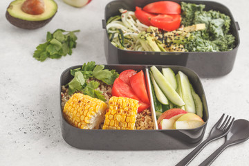 Healthy meal prep containers with quinoa, avocado, corn, zucchini noodles and kale. Takeaway food.