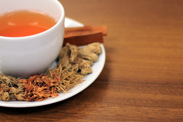 Dry herbs ingredients for brewed healthy herbal teas on a wooden background. Herbal teas beverage for chinese or thai traditional alternative medicine therapy. 