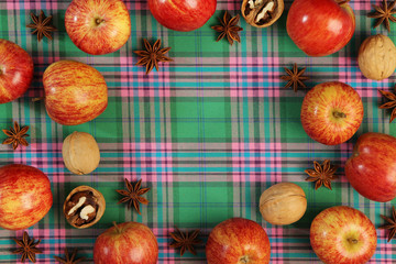 A background with autumn mood formed with apples with free space for text in the center