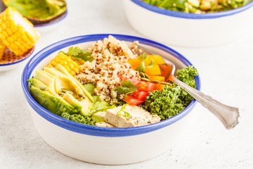 Vegan healthy rainbow salad, buddha bowl with quinoa, tofu, avocado and kale.