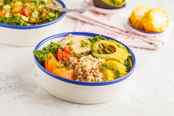 Vegan healthy rainbow salad, buddha bowl with quinoa, tofu, avocado and kale.