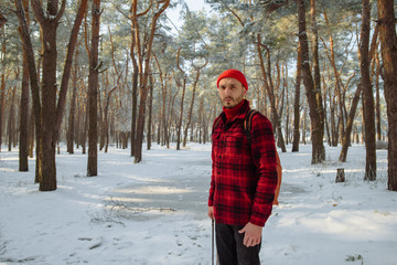 Tourist standing alone outdoor, orange cap and red plaid shirt, jacket. Travel lifestyle and emotions concept. Film effects colors. Wanderlust, hiking. Winter holiday. Christmas.