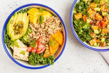 Vegan healthy rainbow salad, buddha bowl with quinoa, tofu, avocado and kale.