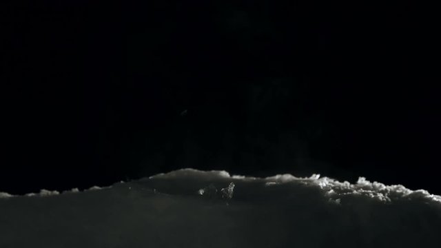 Fragile soap buble freezing and bursts on black background