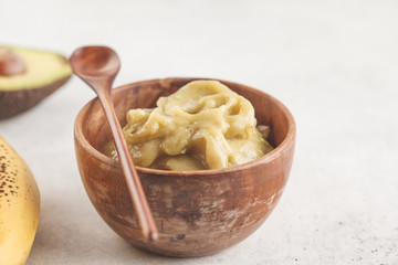 Green vegan banana avocado ice cream in a wooden bowl. Clean eating concept.