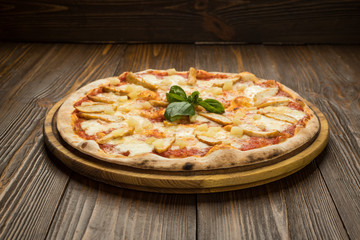 Pizza with chicken breast, pineapple and mozzarella cheese