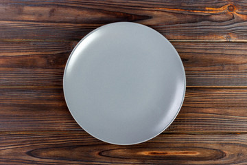 Top view gray Empty round plate on wooden background