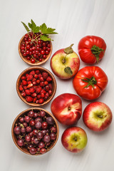 Assortment of red foods on a white background, top view. Fruits and vegetables containing lycopene.