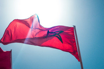 low angle view of moroccan flags against sky