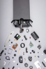 Different parts with a photo camera on a gray background.