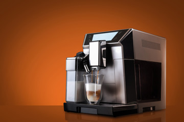Coffee machine without flying coffee beans across it on orange background. Concept studio shooting....