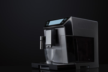 Coffee machine without flying coffee beans across it on dark background. Concept studio shooting. High speed freezing photo