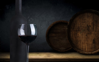 Red wine. Wine. Bottle and glass of Red wine with ripe grapes still life. Red wine Over black background. Wide angle art design with space for your text