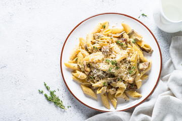 Pasta with white mushrooms in creamy sauce.
