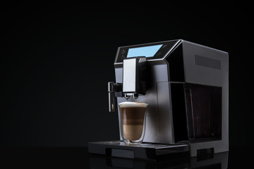 Coffee machine without flying coffee beans across it on dark background. Concept studio shooting....