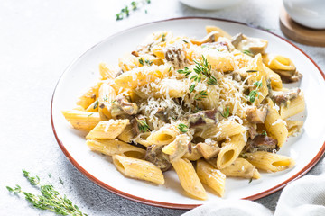 Pasta with white mushrooms in creamy sauce.