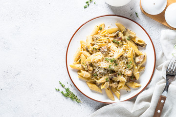Pasta with white mushrooms in creamy sauce.